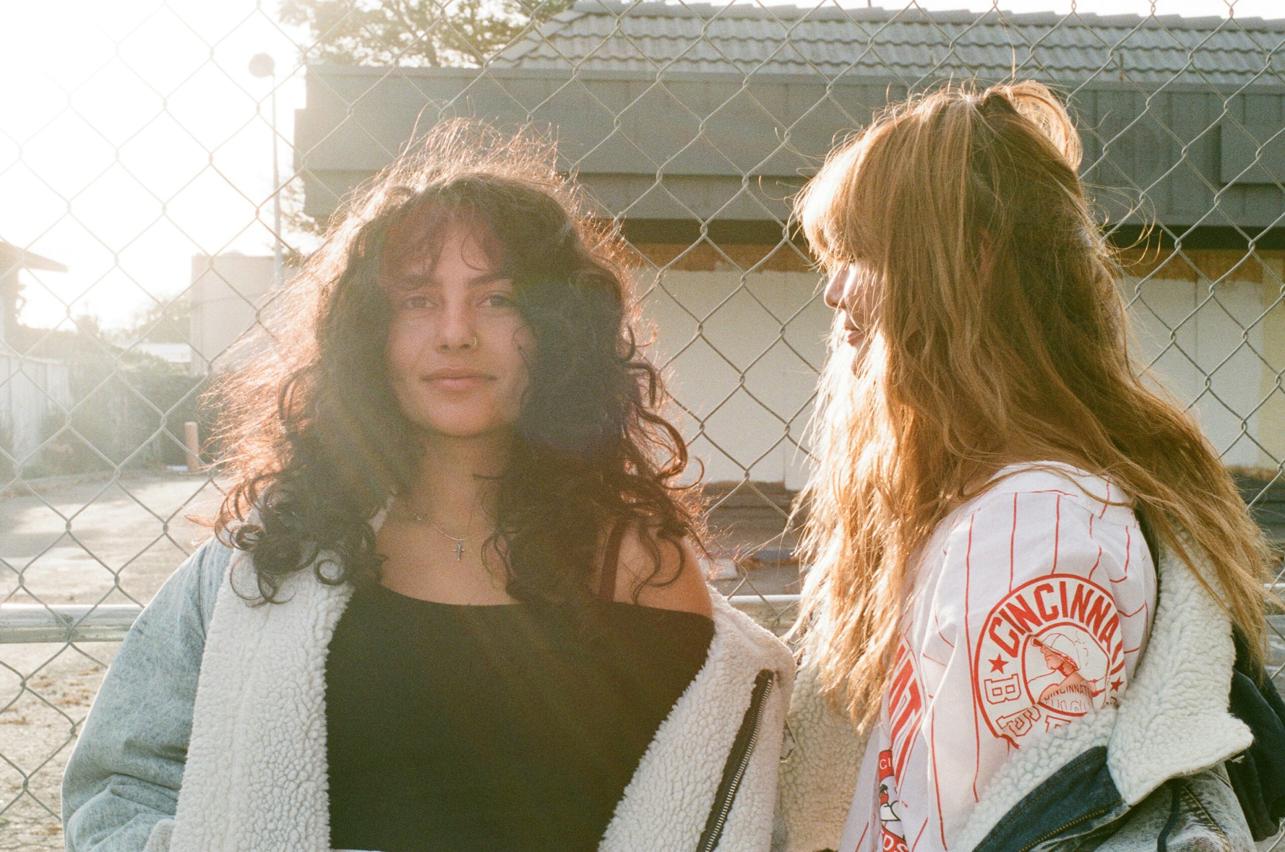 A Couple Of Women Standing Next To Each Other